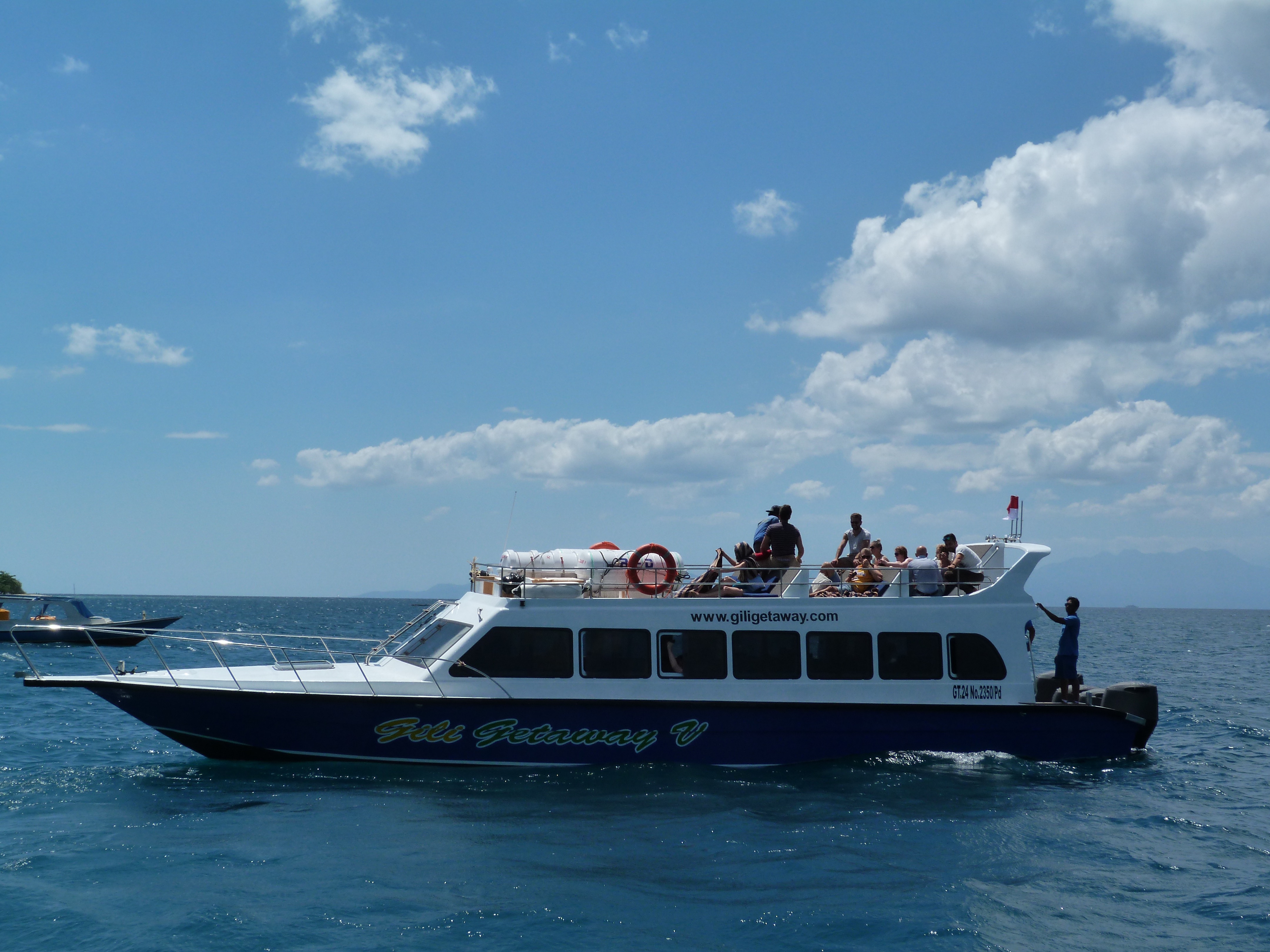 A Gili Getaway fast boat cruising with passengers on the sun deck